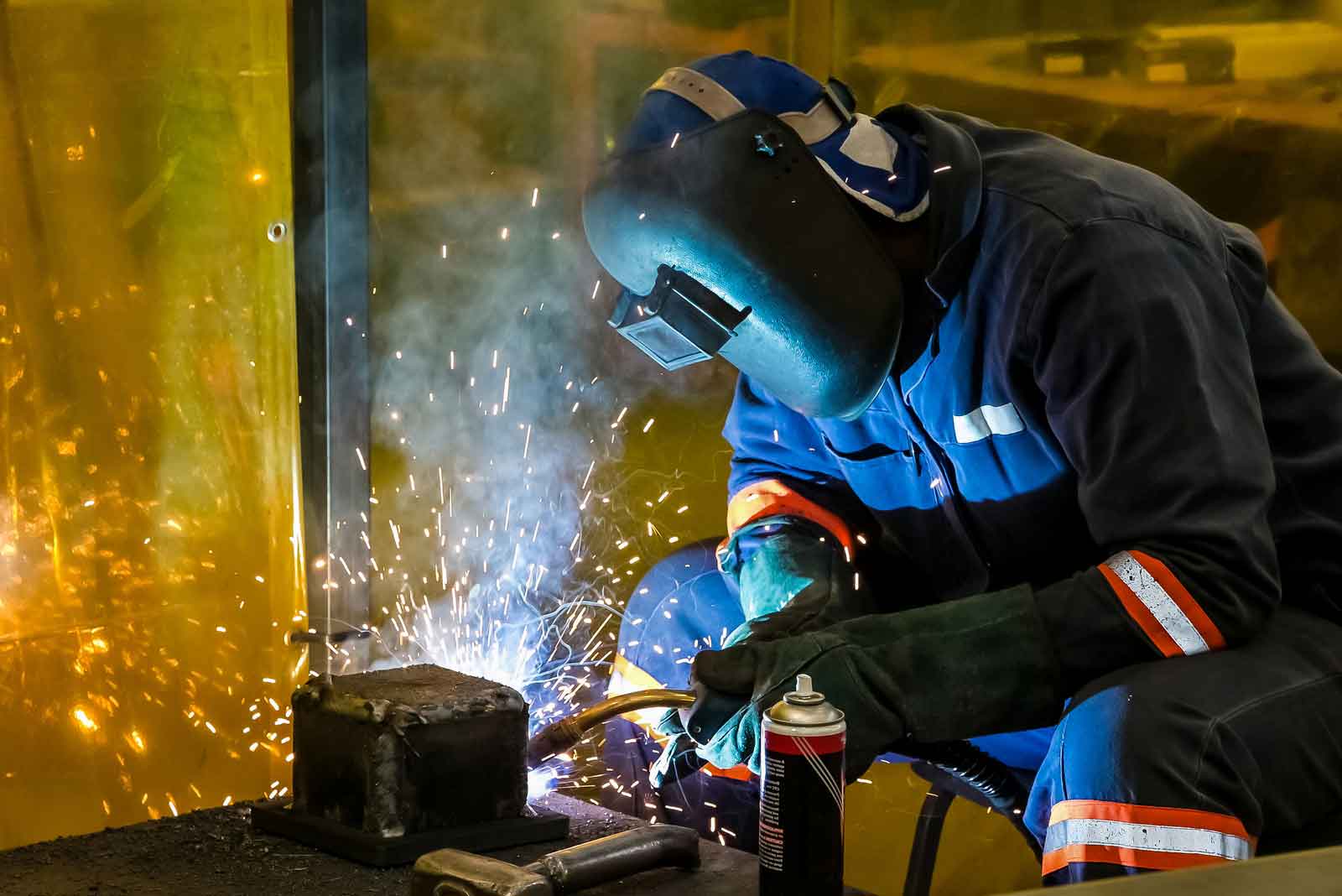 Male working with welding torch
